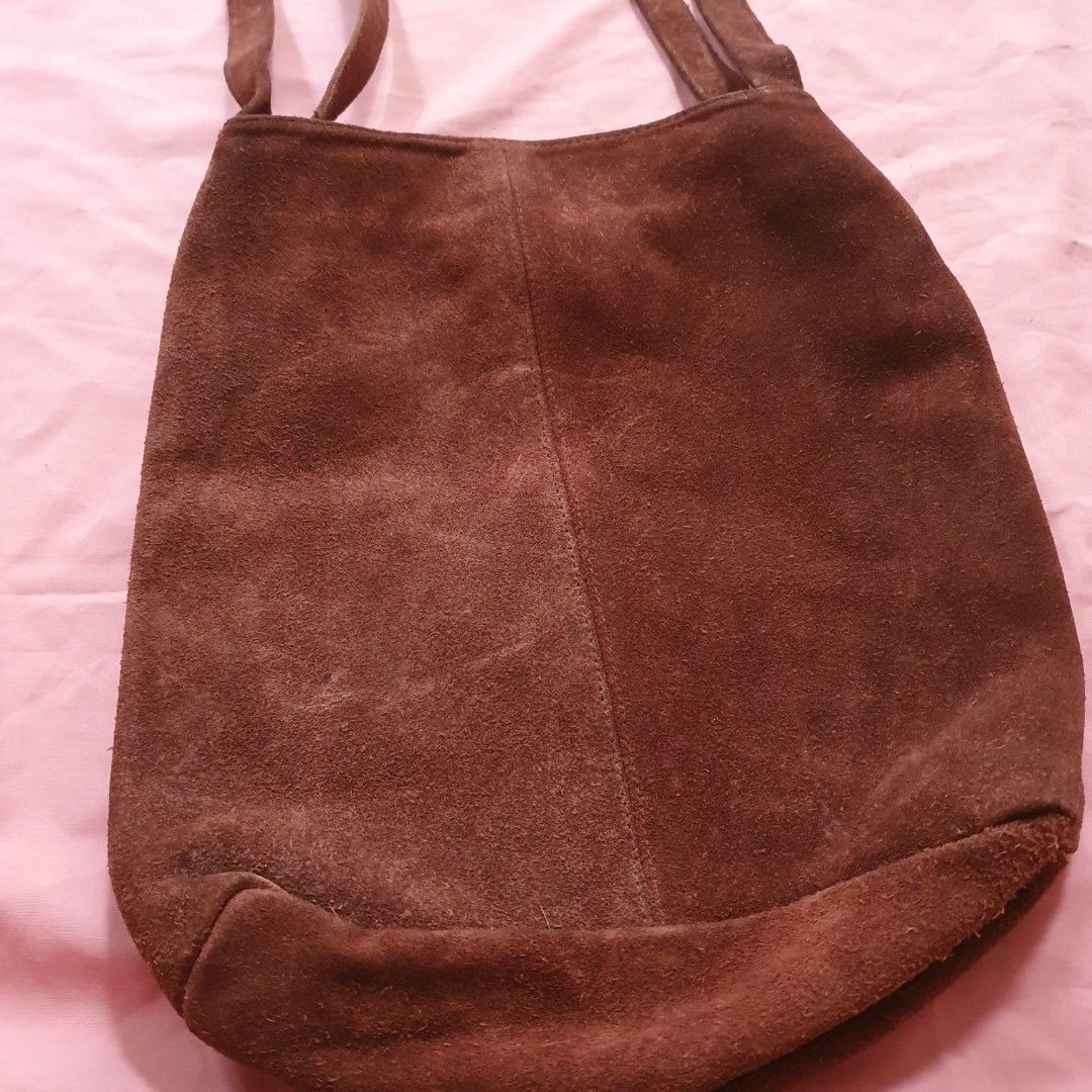 Brown Suede Shoulder Bag (Category: Shoulder Bags) located in Paranaque City. Submitted by cobien (Listing ID 1463461214, Image 3). Description: - Soft brown suede material - Simple design with two comfortable straps - Interior features a stylish patterned lining - Secure magnetic snap closure - Ample space for all your essentials - has signs of use on the - Ideal for everyday use leather.