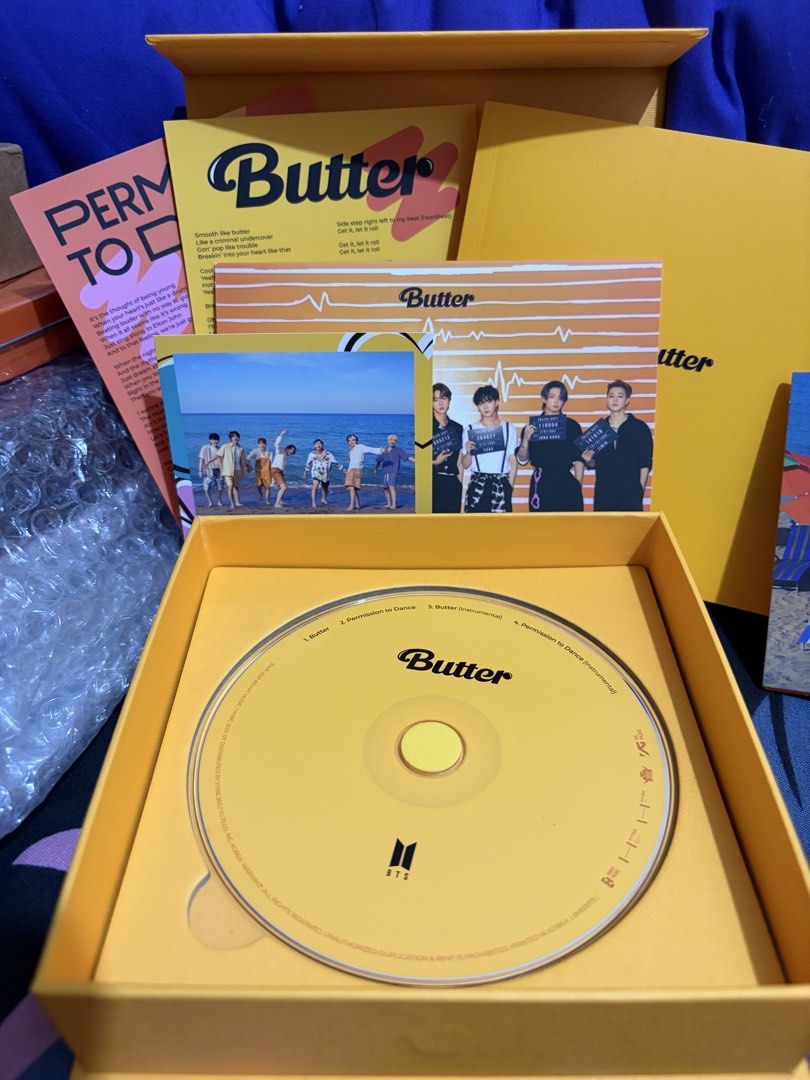 BTS Butter & Permission to Dance CD Set (Category: CDs & DVDs) located in Manila. Submitted by ahnamaesan06047 (Listing ID 1463395911, Image 1). Description: - BTS Butter & Permission to Dance CD Sets - Available in Yellow and Orange versions - Includes: CD, photocard, stickers, and more! - A must-have for any ARMY!.