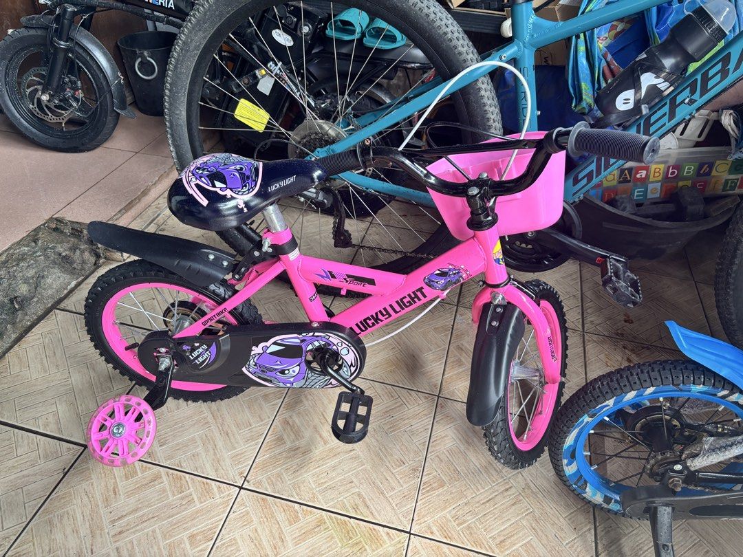 Bundle Kids Bicycle with Training Wheels (Category: Bicycles) located in Quezon City. Submitted by coramalabanan (Listing ID 1463365652, Image 2). Description: - Blue and black kids bike with cool camouflage design and front basket. - Pink Lucky Light kids bike with basket. - Both bikes include training wheels, perfect for young riders learning to pedal. - Ideal for beginners. - Selling as a pair or individually. - Feel free to ask any questions!