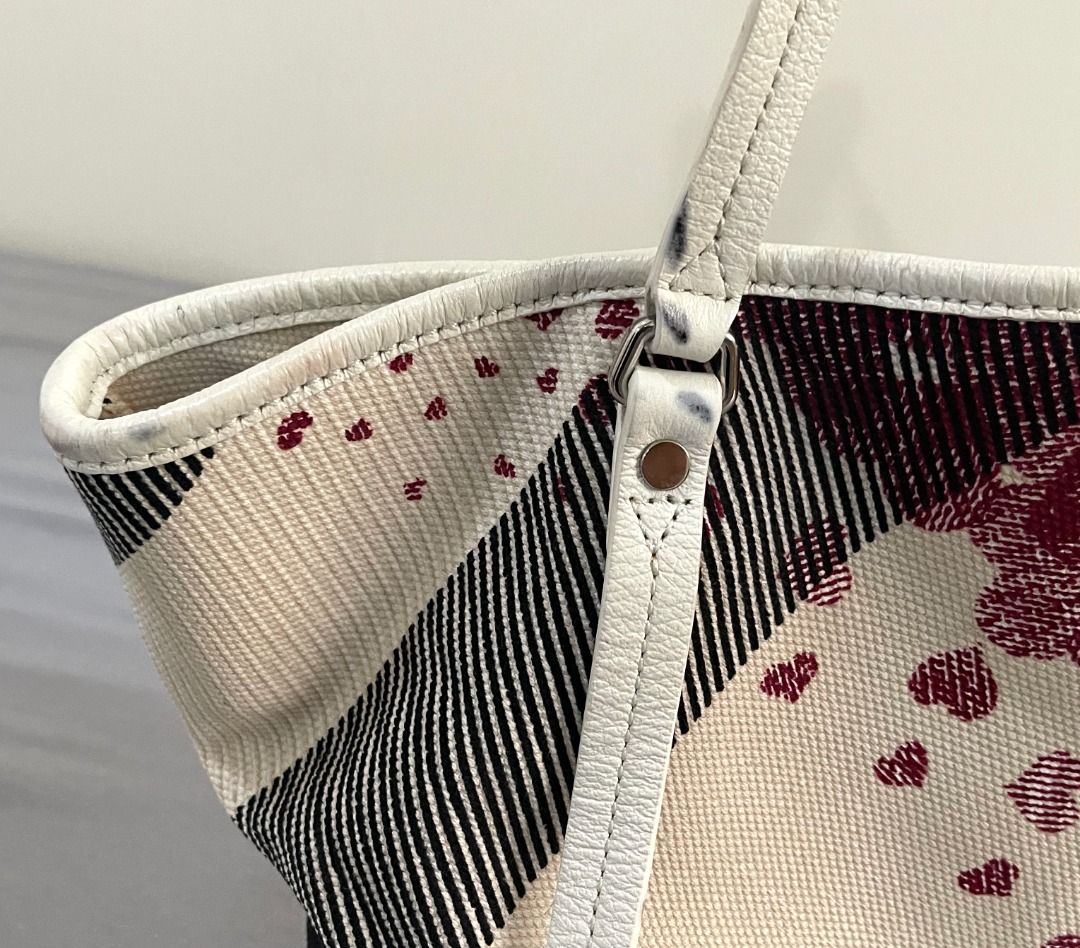 Burberry Canvas Tote Bag with Heart Pattern (Category: Tote Bags) located in General Tinio. Submitted by the_bargainhunter (Listing ID 1463349372, Image 2). Description: - Authentic Burberry check canvas tote bag - Features a cute heart print on one side - Durable leather straps and trim - Plenty of life left, great for everyday use.