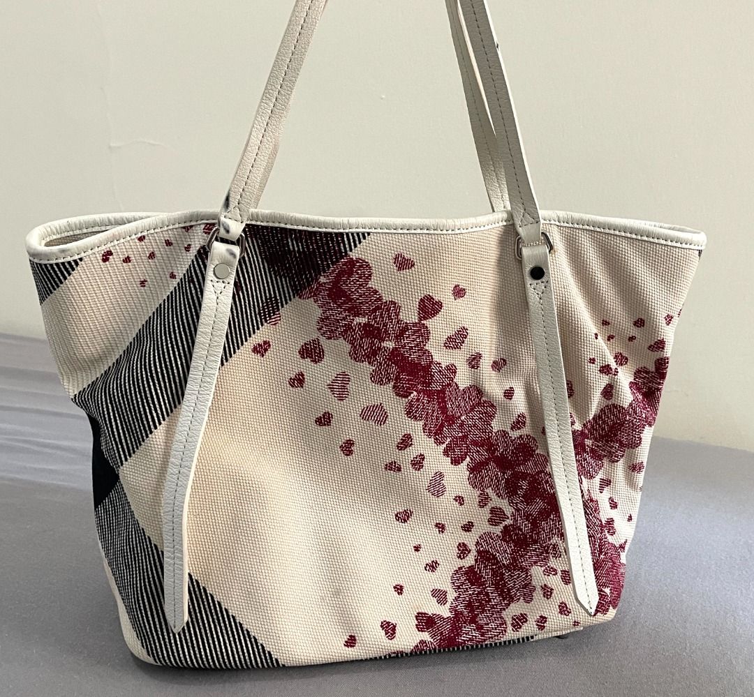 Burberry Canvas Tote Bag with Heart Pattern (Category: Tote Bags) located in General Tinio. Submitted by the_bargainhunter (Listing ID 1463349372, Image 1). Description: - Authentic Burberry check canvas tote bag - Features a cute heart print on one side - Durable leather straps and trim - Plenty of life left, great for everyday use.