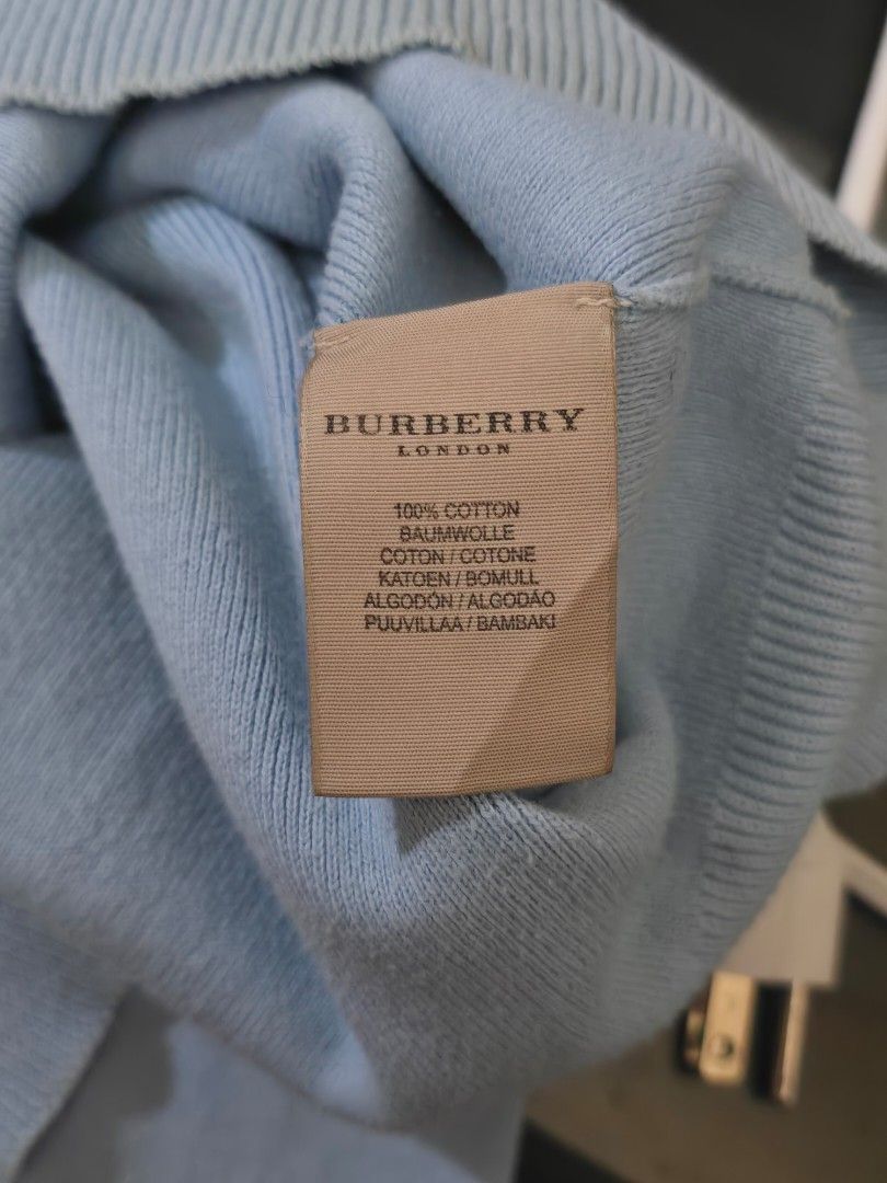 Burberry Light Blue V‑Neck Knit Sweater (Category: Coats, Jackets and Outerwear) located in Mexico. Submitted by silverkatie429 (Listing ID 1463549292, Image 3). Description: This is a light blue V‑neck sweater crafted from soft knit fabric, featuring a subtle embroidered logo on the left chest. It offers a clean, minimalist look with ribbed cuffs and hem, perfect for layering or casual streetwear..