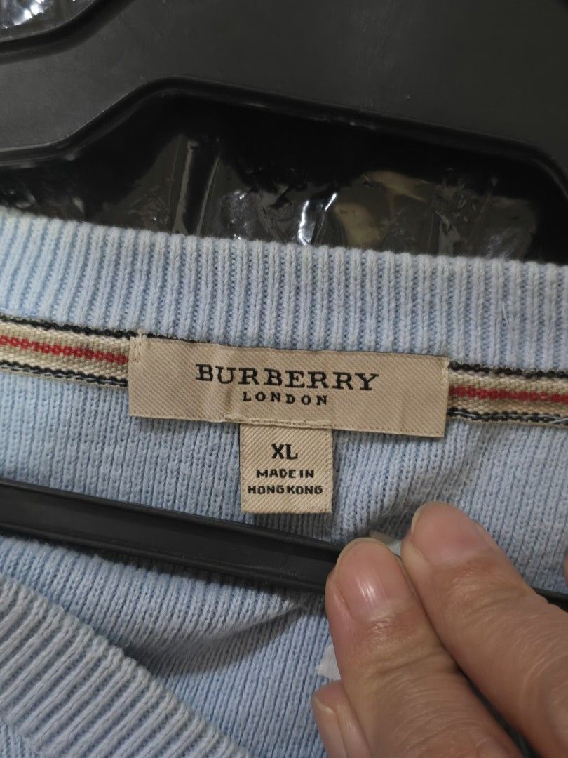 Burberry Light Blue V‑Neck Knit Sweater (Category: Coats, Jackets and Outerwear) located in Mexico. Submitted by silverkatie429 (Listing ID 1463549292, Image 2). Description: This is a light blue V‑neck sweater crafted from soft knit fabric, featuring a subtle embroidered logo on the left chest. It offers a clean, minimalist look with ribbed cuffs and hem, perfect for layering or casual streetwear..