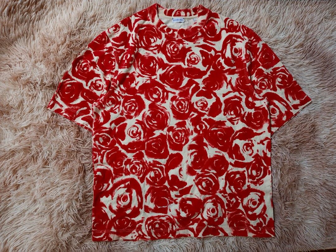 Burberry Rose Print T-Shirt (Category: Tshirts & Polo Shirts ) located in Boston. Submitted by johnpaulvi30029 (Listing ID 1463402428, Image 1). Description: - Authentic Burberry tee - Cream base with vibrant all-over red rose print - Short sleeves and crew neck - Perfect statement piece for any outfit - Versatile for dressing up or down.