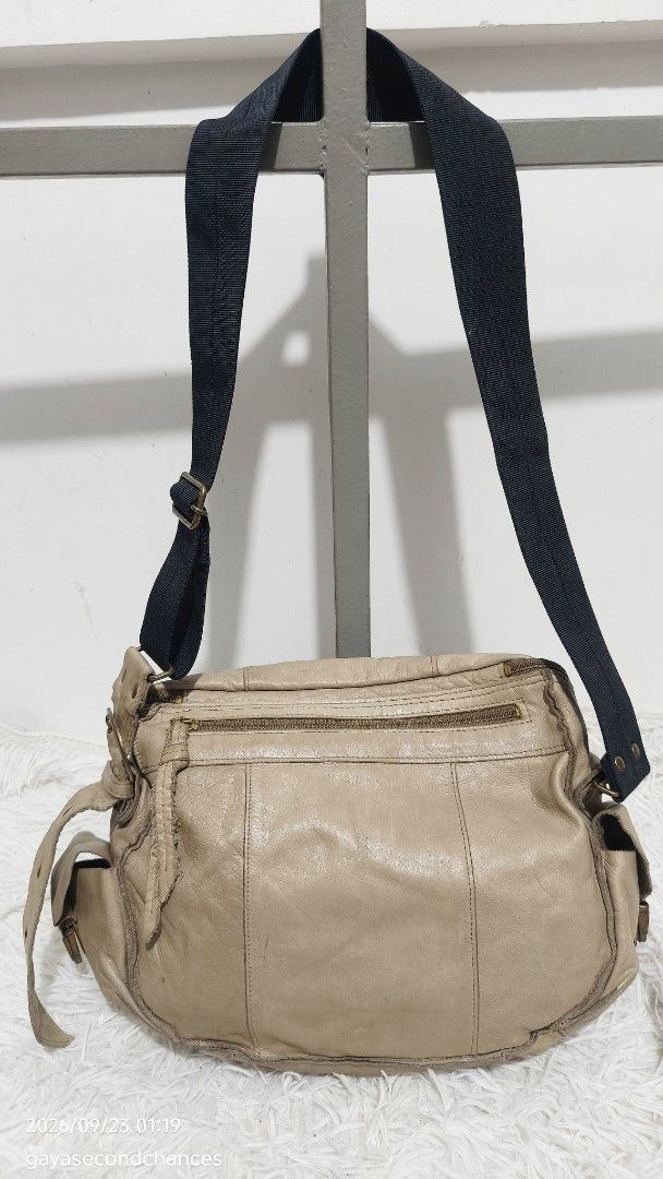 CARGO STYLE LEATHER CROSSBODY BAG (Category: Shoulder Bags) located in Kalibo. Submitted by secondchances.thriftsh8p (Listing ID 1463530257, Image 2). Description: - Cool beige leather shoulder bag - Main zip compartment - Front zip pocket - Adjustable black fabric strap - Signs of wear on leather and hardware (vintage vibe) - Spacious interior - Perfect for everyday use.
