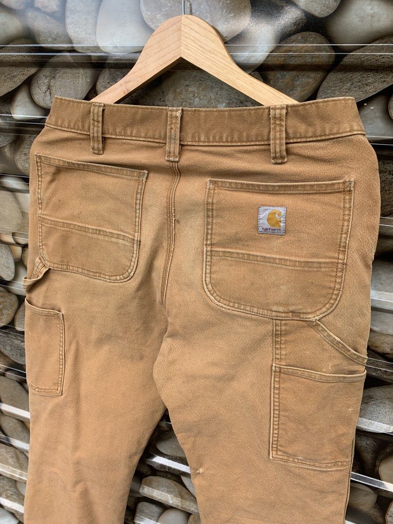 Carhartt Work Pants Tan Double Knee Carpenter Style (Category: Jeans) located in Aloran. Submitted by chester78864 (Listing ID 1463493410, Image 2). Description: - Classic tan Carhartt work pants - Iconic double knee design for extra durability - Multiple pockets for ample storage - Authentic worn-in look from use - Ideal for everyday wear or DIY projects.