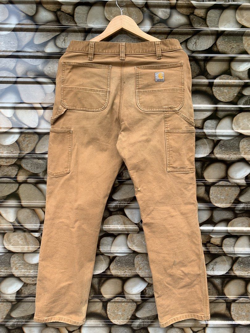 Carhartt Work Pants Tan Double Knee Carpenter Style (Category: Jeans) located in Aloran. Submitted by chester78864 (Listing ID 1463493410, Image 1). Description: - Classic tan Carhartt work pants - Iconic double knee design for extra durability - Multiple pockets for ample storage - Authentic worn-in look from use - Ideal for everyday wear or DIY projects.