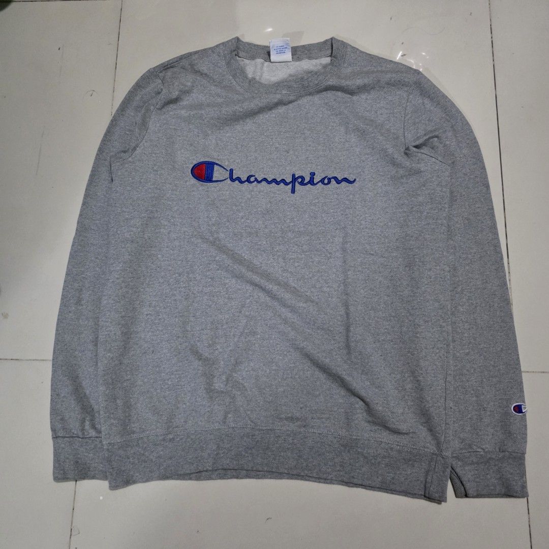 Champion Grey Crewneck Sweatshirt (Category: Coats, Jackets and Outerwear) located in Quezon City. Submitted by kick_mnl (Listing ID 1463374109, Image 1). Description: - Grey Champion sweatshirt - Classic vertical embroidered logo on front - Smaller logo embroidered on sleeve - Crewneck style - Made from comfortable material - Ideal for casual wear.