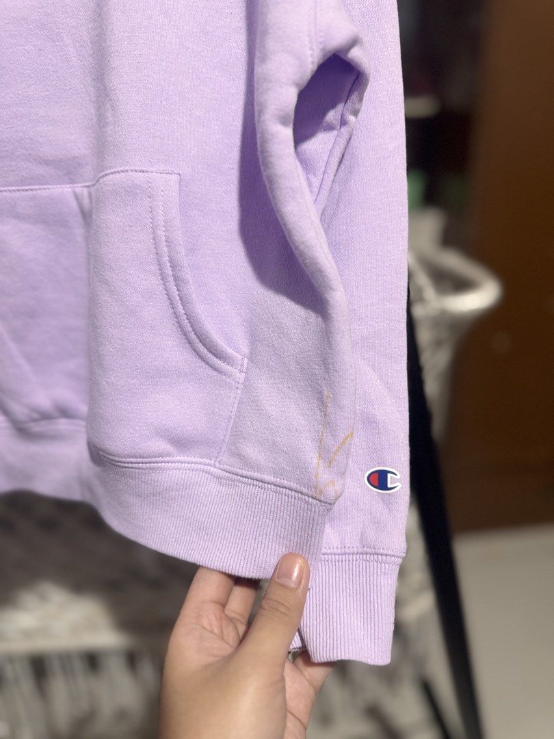 Champion Lavender Crewneck Sweatshirt (Category: Babies & Kids Fashion) located in Santa Rosa. Submitted by yasss23 (Listing ID 1463356368, Image 3). Description: - Cute lavender Champion sweatshirt - Classic Champion logo on front - Features a kangaroo pocket - Small stain on the right cuff (see last photo) 6T.