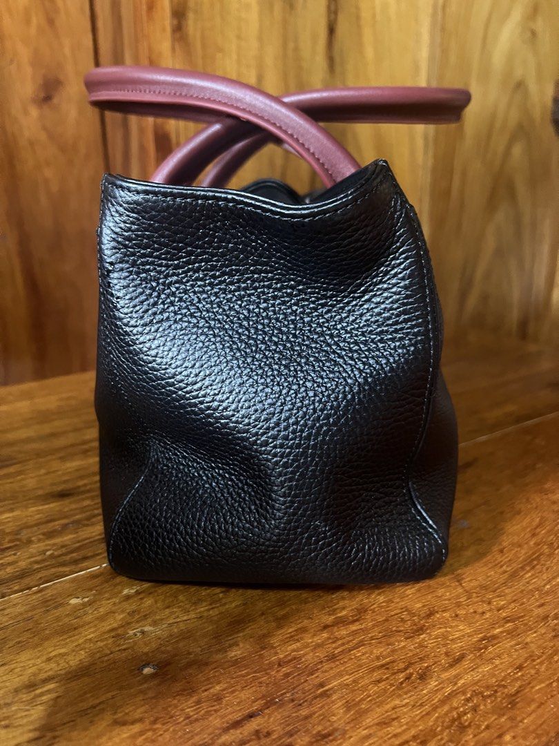 Chanel Cerf East West Tote (Category: Luxury Bags & Wallets) located in Baguio. Submitted by Passionista_2600 (Listing ID 1463554587, Image 3). Description: - Classic black leather tote bag - Burgundy leather top handles -3 compartments with detachable pouch inside - Silver hardware details, hexa screw, chanel underzip and puller - Protective studs on the bottom - Spacious and stylish for everyday use -L12.2in x H6.7in x W5.3in -comes with dustba