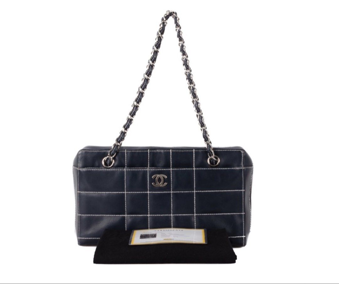 CHANEL Chocolate Bar Black Square Stitch Bag (Category: Luxury Bags & Wallets) located in Taguig. Submitted by luxeinofficial (Listing ID 1463348552, Image 2). Description: CHANEL Chocolate Bar Black Square Stitch Bag SKU: Y2H7GP Gender: Ladies Material: Lambskin leather Stamp: 7037705 Year: 2002 - 2003 Interior: One zip pocket, one open pocket and one main compartment Measurements: 11.5”L X 3.4”W X 6.75”H Handle Drop: 9.1” Hardware: Silver tone 