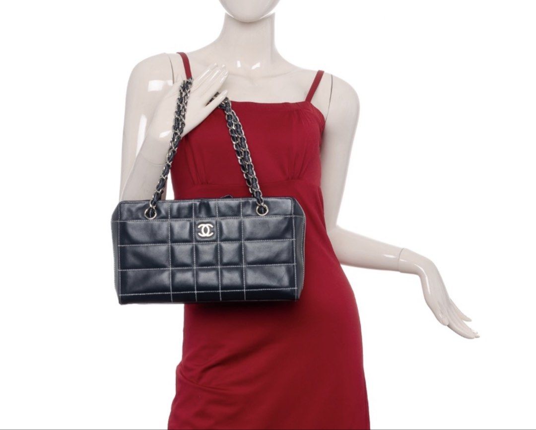 CHANEL Chocolate Bar Black Square Stitch Bag (Category: Luxury Bags & Wallets) located in Taguig. Submitted by luxeinofficial (Listing ID 1463348552, Image 1). Description: CHANEL Chocolate Bar Black Square Stitch Bag SKU: Y2H7GP Gender: Ladies Material: Lambskin leather Stamp: 7037705 Year: 2002 - 2003 Interior: One zip pocket, one open pocket and one main compartment Measurements: 11.5”L X 3.4”W X 6.75”H Handle Drop: 9.1” Hardware: Silver tone 