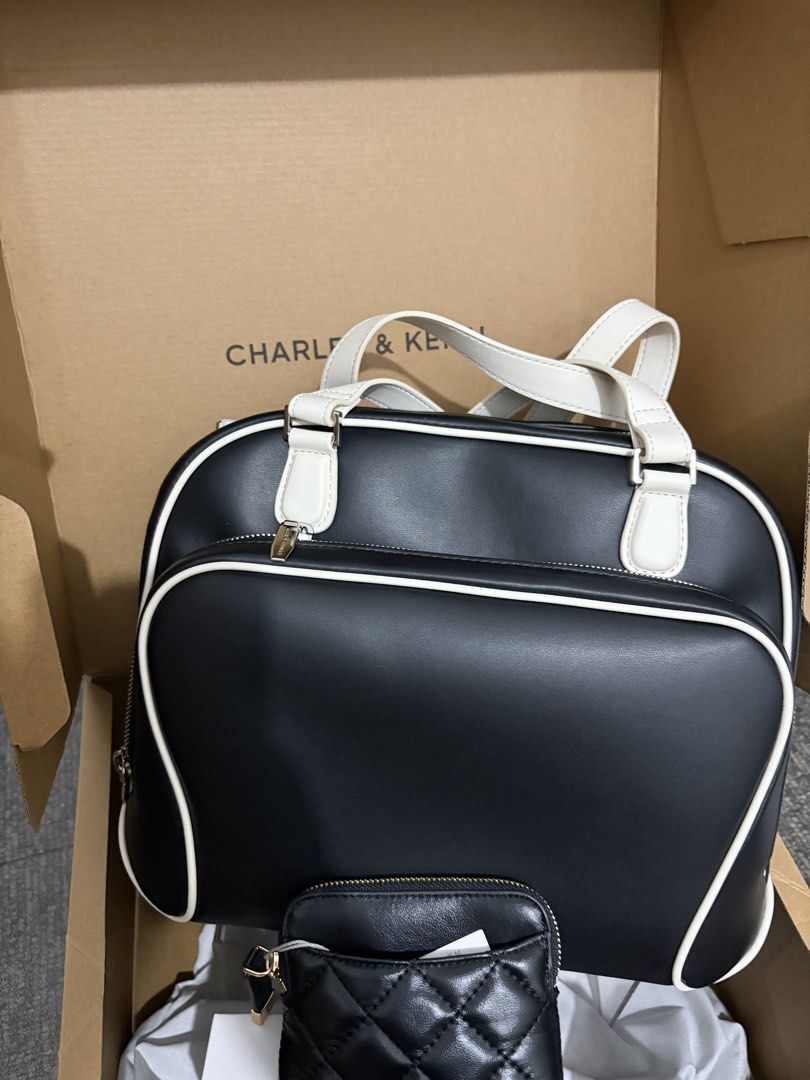 Charles & Keith Black and White Handbag (Category: Luxury Bags & Wallets) located in Carmona. Submitted by allonahkhrizelle-96238 (Listing ID 1463515222, Image 1). Description: This item is part of our Online Exclusive selection, which consists of unique colourways and designs that are only available for purchase online. This Nelly backpack has a black body with white straps and trims. It also features a roomy front pocket and soft top handles. C