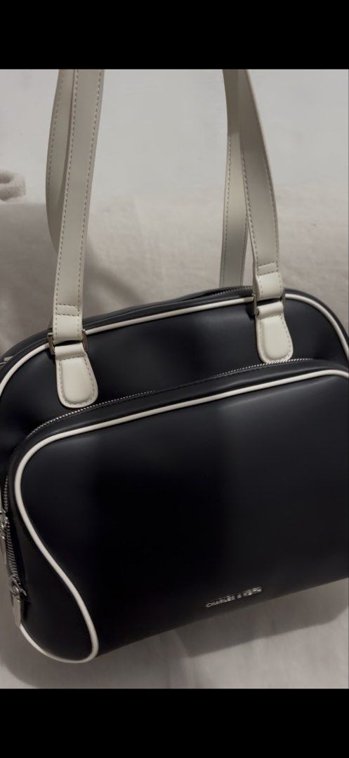 Charles & Keith Black and White Handbag (Category: Luxury Bags & Wallets) located in Carmona. Submitted by allonahkhrizelle-96238 (Listing ID 1463515222, Image 3). Description: This item is part of our Online Exclusive selection, which consists of unique colourways and designs that are only available for purchase online. This Nelly backpack has a black body with white straps and trims. It also features a roomy front pocket and soft top handles. C