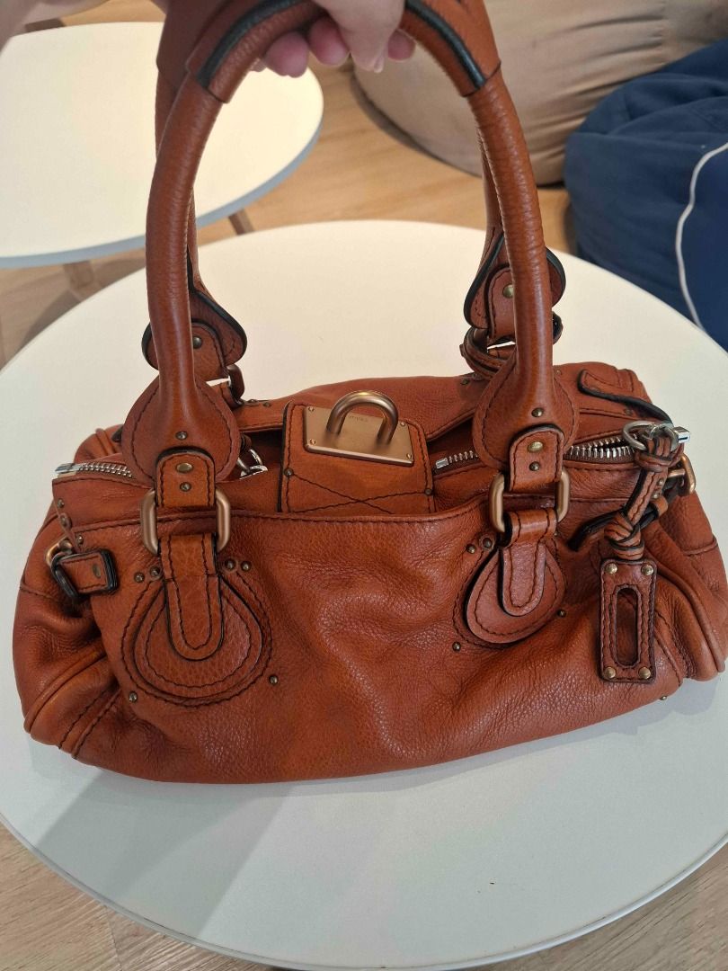 Chloe Paddington (Category: Luxury Bags & Wallets) located in Manila. Submitted by mlgrz (Listing ID 1463482804, Image 3). Description: - YKK Zipper - Genuine Heavy Leather - Has code (2006 bag) - Cognac, Burnt Orange, or Ecureuil Brown Color RFS - Used once or twice - Just stored in closet (with plastic) - Lost lock Price is negotiable for sure buyers.