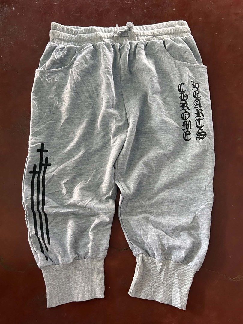 Chrome Hearts Grey Sweatpants (Category: Joggers) located in Manila. Submitted by bud_thriftt (Listing ID 1463398052, Image 1). Description: - Grey sweatpants with iconic Chrome Hearts logo on the side. - Stylish star graphics running down the leg. - Unique cross design featured on the back pocket. - Comfortable elastic waistband with adjustable drawstring. - Finished with cuffed ankles for a snug fit. - Designed for a comfortable and relaxed fit