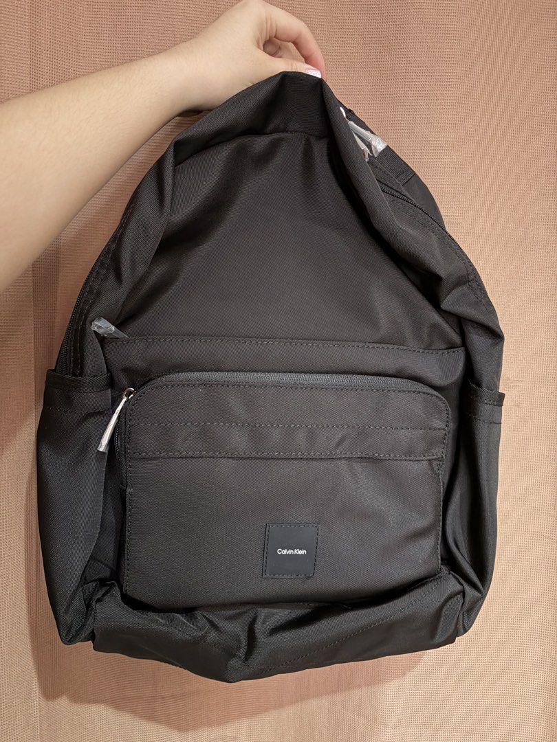 CK Utility Backpack (Category: Backpacks) located in Manila. Submitted by alyzzadelgado (Listing ID 1463338529, Image 1). Description: 5 compartments, 2 side pockets, laptop sleeve, luggage sleeve at the back Never used Rfs: declutter.