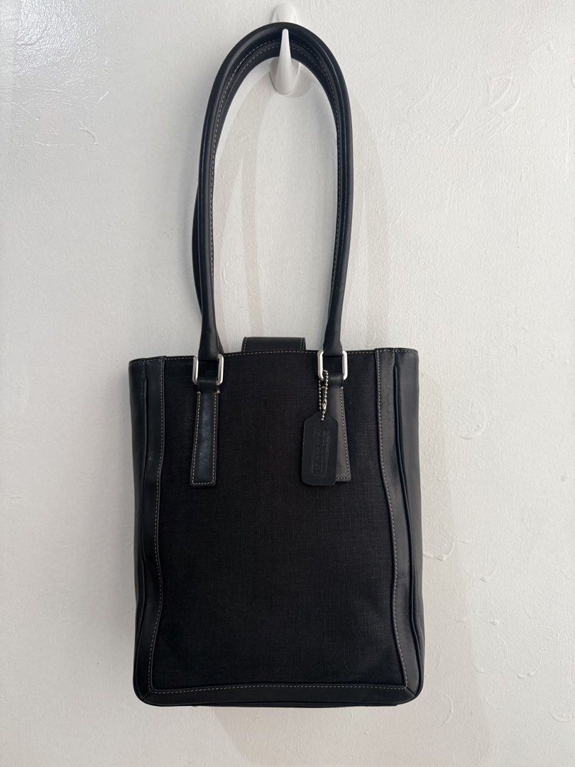 Coach Black Canvas Leather Trim Tote Bag (Category: Luxury Bags & Wallets) located in Las Pinas. Submitted by tati_finds (Listing ID 1463383689, Image 2). Description: - Classic black Coach tote bag - Durable canvas body with elegant leather trim and handles - Stylish silver hardware accents - Includes authentic Coach leather hang tag - Ample interior space for all your essentials - Ideal for everyday wear and versatility.