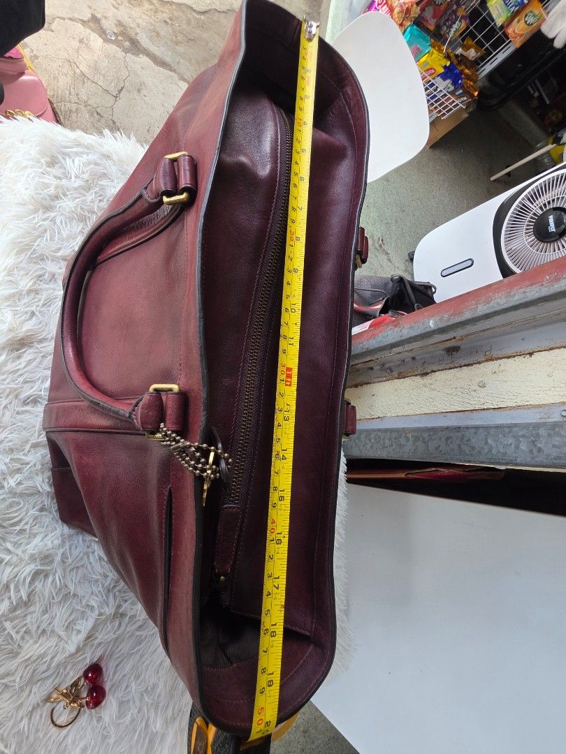 Coach Burgundy Leather Tote Bag (Category: Luxury Bags & Wallets) located in Lemery. Submitted by venus23 (Listing ID 1463419849, Image 3). Description: - Authentic Coach burgundy leather tote bag - Classic and timeless design - Sturdy handles for comfortable carrying - Ample interior space for all your essentials - Elegant gold-tone hardware details - Shows some signs of wear, consistent with normal use - Approximate dimensions: 19 inches wide x