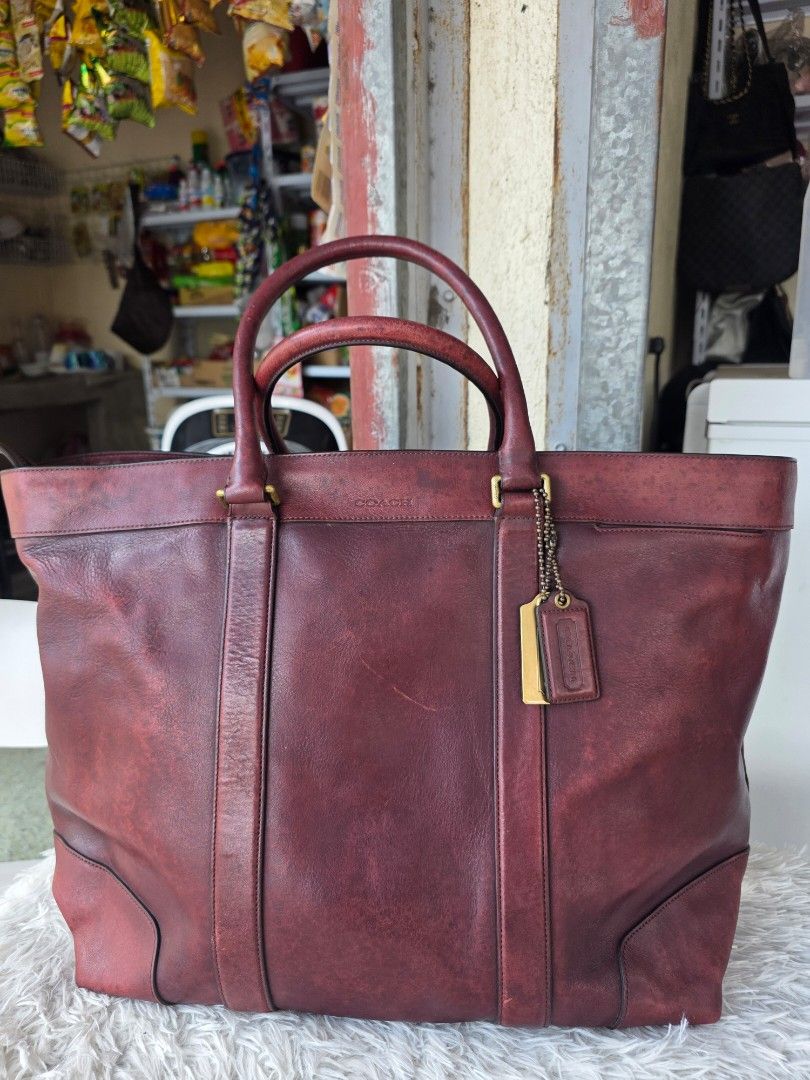 Coach Burgundy Leather Tote Bag (Category: Luxury Bags & Wallets) located in Lemery. Submitted by venus23 (Listing ID 1463419849, Image 1). Description: - Authentic Coach burgundy leather tote bag - Classic and timeless design - Sturdy handles for comfortable carrying - Ample interior space for all your essentials - Elegant gold-tone hardware details - Shows some signs of wear, consistent with normal use - Approximate dimensions: 19 inches wide x