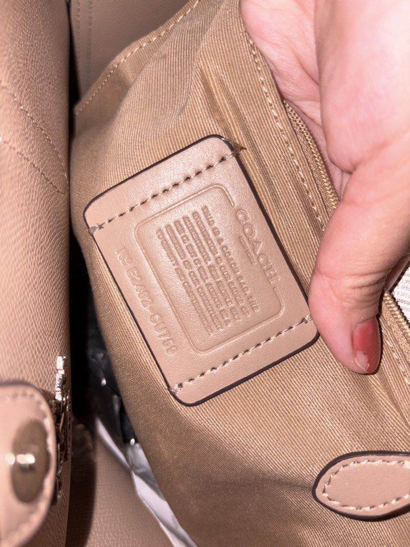 Coach City Tote Bag Beige (Category: Luxury Bags & Wallets) located in Taguig. Submitted by prelovedbydein (Listing ID 1463501384, Image 3). Description: - NGA Coach tote bag (u need to legit check if maselan) - Signature beige print with tan leather trim and handles - Interior zip pocket and slip pockets - Includes Coach hangtag - Ideal for everyday use.