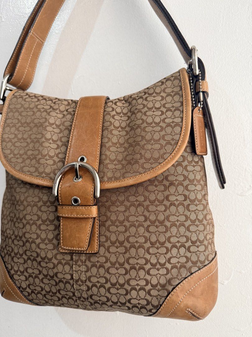Coach Monogram Canvas & Leather Shoulder Bag (Category: Luxury Bags & Wallets) located in Las Pinas. Submitted by tati_finds (Listing ID 1463383042, Image 3). Description: - Classic Coach shoulder and crossbody bag - Brown monogram canvas with tan leather trim - Silver buckle closure on front flap - Spacious interior for essentials - Ideal for everyday use - Comes with original strap instructions.