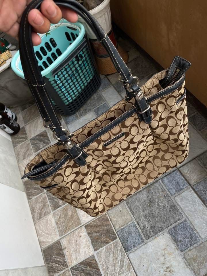 Coach Monogram Canvas Tote Bag (Category: Luxury Bags & Wallets) located in Manila. Submitted by zayneeee. (Listing ID 1463555308, Image 3). Description: - Classic Coach tote bag - Signature brown and tan monogram print - Black leather trim and handles - Secure zipper closure - Interior zippered pocket and slip pockets - Made in Vietnam - Serial number: NPJ1059-F16339 - Ideal for everyday use.