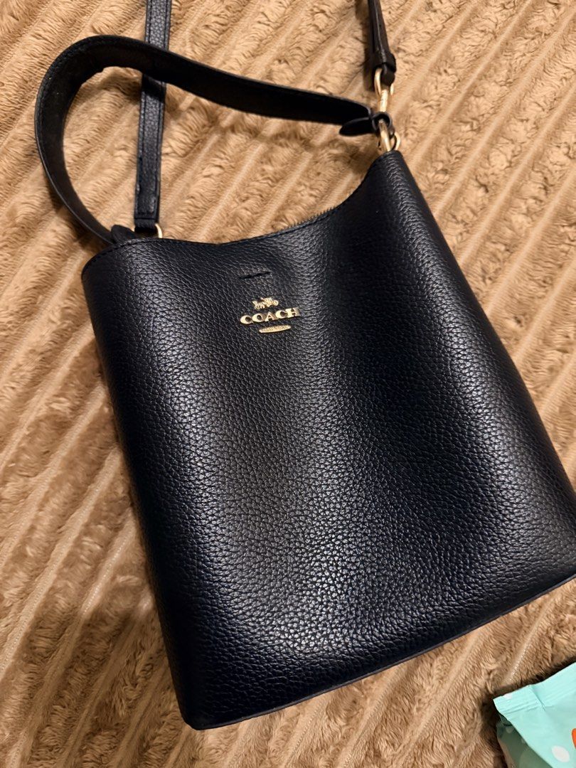 Coach Pebbled Leather Bucket Bag Navy (Category: Luxury Bags & Wallets) located in Quezon City. Submitted by jammiras (Listing ID 1463486136, Image 1). Description: - Brand: Coach - Material: Navy blue pebbled leather - Hardware: Gold-tone - Features: Main compartment, interior zip pocket, adjustable crossbody strap - Ideal for: Everyday use - Issue: Shorter strap slightly worn out.