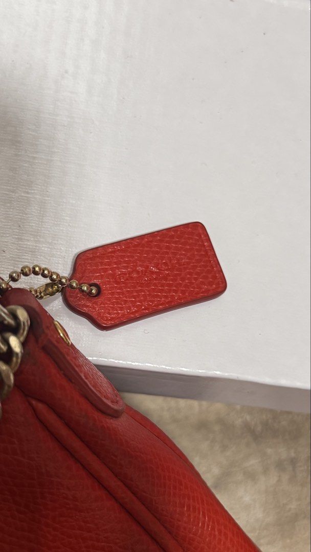 Coach Red Crosstown Crossbody (Category: Luxury Bags & Wallets) located in Pasig City. Submitted by sdpii (Listing ID 1463481628, Image 2). Description: - Authentic Coach red leather shoulder bag - Features a stylish gold turn-lock closure - Comes with a detachable gold chain strap - Includes a longer, detachable leather strap - Beautiful pebbled leather texture - Small Coach logo tag attached - Ideal for evening events or carrying just the essen