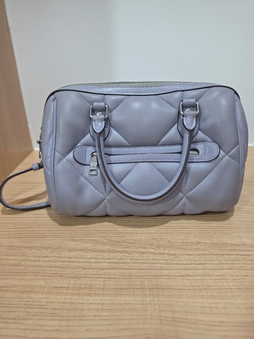Coach Rowan Satchel (Mist) (Category: Luxury Bags & Wallets) located in Manila. Submitted by flyfreee (Listing ID 1463374143, Image 2). Description: - Authentic Coach Rowan Satchel with Puffy Diamond Quilting - Top handles for carrying - Detachable shoulder strap for versatility - Secure zipper closure - Interior Coach brand tag - Comes with dust bag that has a hole on the side but can be fixed - bought from Coach in Gilroy Premium Outlets in Cal