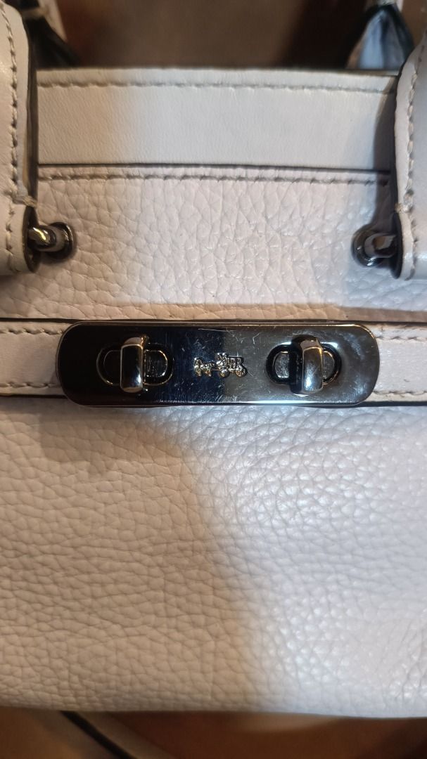 Coach Swagger 20 Pebble Leather Light Blue Handbag (Category: Luxury Bags & Wallets) located in Subic. Submitted by lyziez_thrift (Listing ID 1463549458, Image 2). Description: - Light blue Coach Swagger 20 bag - Genuine pebble leather - Top handles - Detachable chain strap - Black metal hardware - Minor scuffs on bottom edge - Clean interior - Ideal for everyday use.
