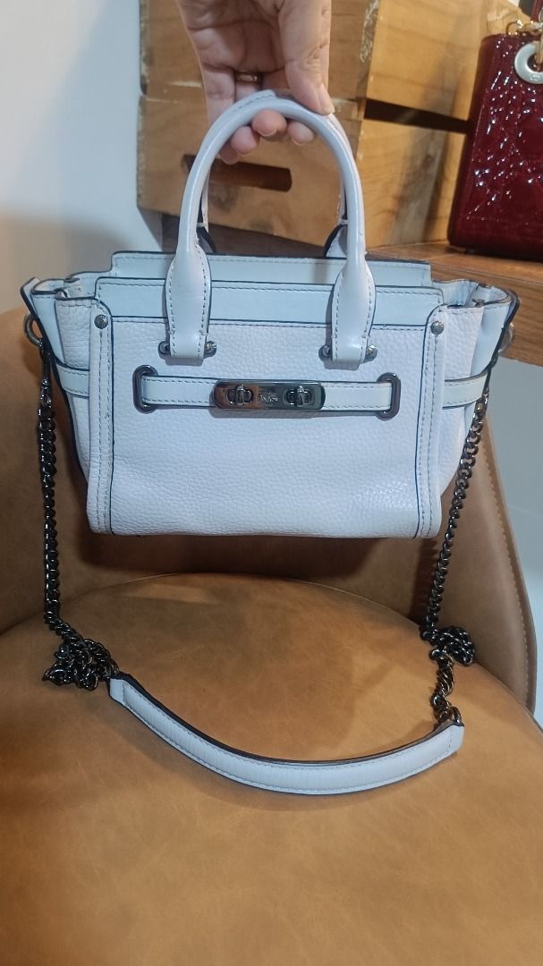 Coach Swagger 20 Pebble Leather Light Blue Handbag (Category: Luxury Bags & Wallets) located in Subic. Submitted by lyziez_thrift (Listing ID 1463549458, Image 1). Description: - Light blue Coach Swagger 20 bag - Genuine pebble leather - Top handles - Detachable chain strap - Black metal hardware - Minor scuffs on bottom edge - Clean interior - Ideal for everyday use.