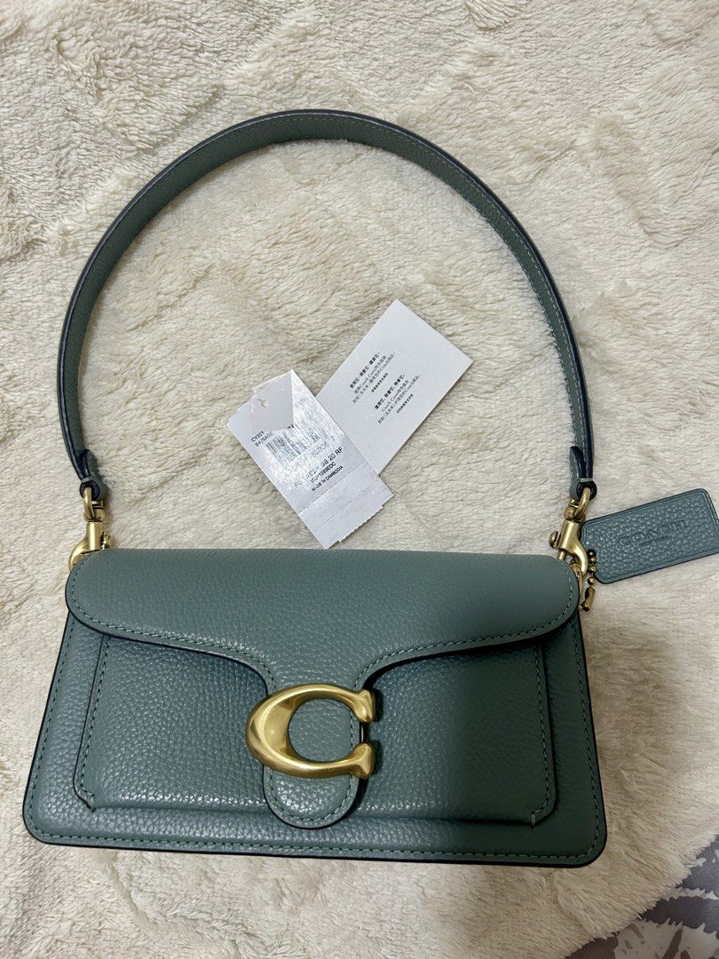Coach Tabby Bag Genuine Pebbled Leather (Category: Luxury Bags & Wallets) located in Malabon City. Submitted by jenjerenjen13 (Listing ID 1463433097, Image 1). Description: - Authentic Coach Tabby Bag - color sage green - Genuine Pebbled Leather - Iconic Gold C Hardware - preloved - original - size 20 (mini) - with tag , coach dustbag , can provide receipt - with long strap - 9/10 condition.