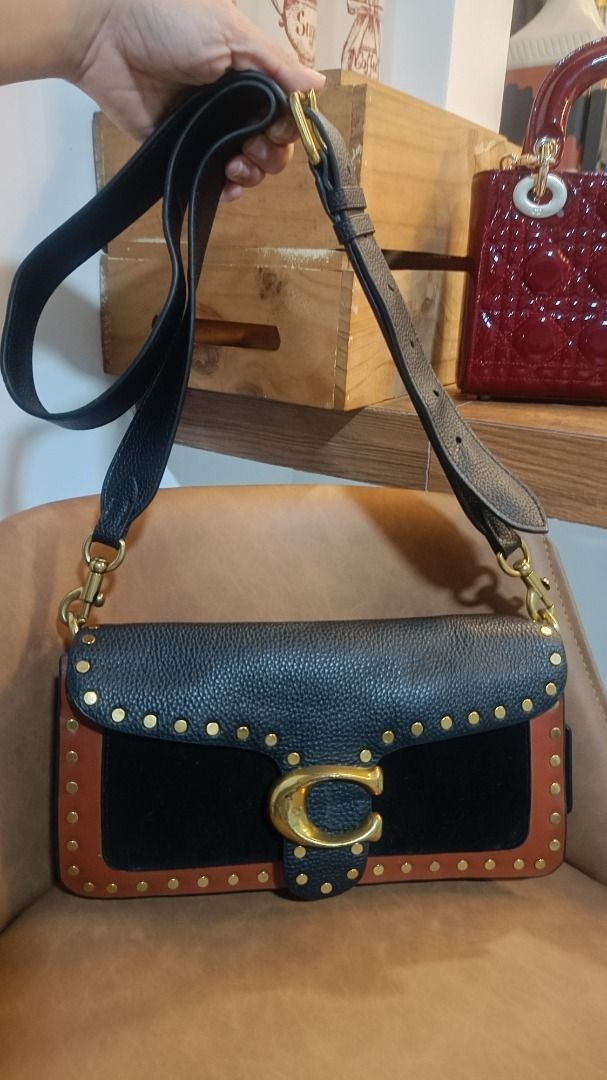 Coach Tabby Shoulder Bag with Studs (Category: Luxury Bags & Wallets) located in Subic. Submitted by lyziez_thrift (Listing ID 1463549514, Image 1). Description: - Authentic Coach shoulder bag in classic black and brown. - Elegant gold hardware with eye-catching stud details. - Adjustable strap for comfortable wear. - Spacious main compartment with an additional inner pocket. - Versatile design, ideal for daily errands or evening events..