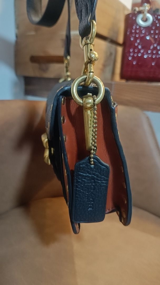 Coach Tabby Shoulder Bag with Studs (Category: Luxury Bags & Wallets) located in Subic. Submitted by lyziez_thrift (Listing ID 1463549514, Image 2). Description: - Authentic Coach shoulder bag in classic black and brown. - Elegant gold hardware with eye-catching stud details. - Adjustable strap for comfortable wear. - Spacious main compartment with an additional inner pocket. - Versatile design, ideal for daily errands or evening events..