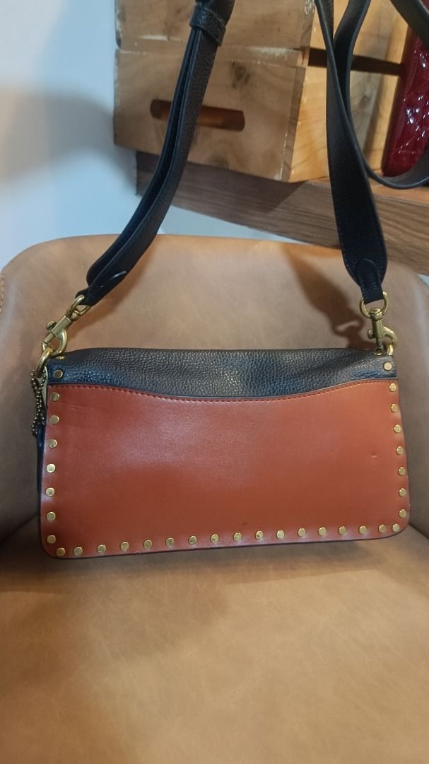 Coach Tabby Shoulder Bag with Studs (Category: Luxury Bags & Wallets) located in Subic. Submitted by lyziez_thrift (Listing ID 1463549514, Image 3). Description: - Authentic Coach shoulder bag in classic black and brown. - Elegant gold hardware with eye-catching stud details. - Adjustable strap for comfortable wear. - Spacious main compartment with an additional inner pocket. - Versatile design, ideal for daily errands or evening events..