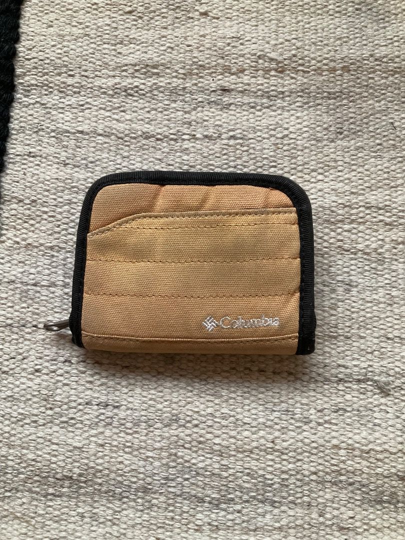 Columbia Wallet (Category: Wallets & Card holders) located in Mandaluyong City. Submitted by philbert420 (Listing ID 1463425196, Image 1). Description: - Tan Columbia wallet - Zippered closure for security - Multiple interior compartments for cards and cash - Convenient keyring attachment on the outside - Compact size, perfect for travel or everyday use.