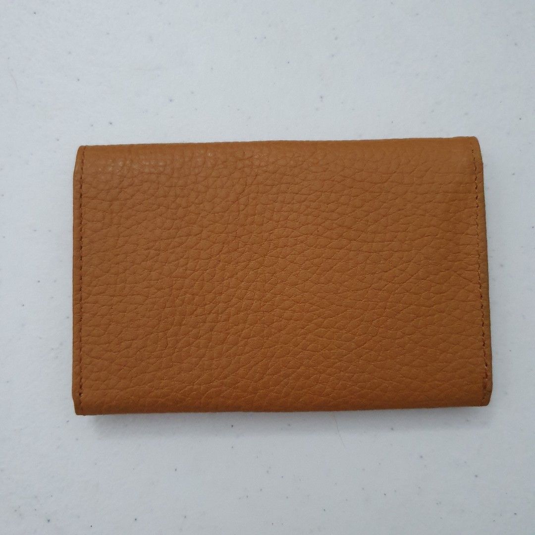 Concord Leather Card Holder Wallet Tan (Category: Wallets & Card holders) located in Paranaque City. Submitted by cobien (Listing ID 1463449522, Image 2). Description: - Genuine tan leather card holder - Textured pebble grain finish - Multiple interior slots for cards - Embossed Concord logo inside - Slim and pocket-friendly design - Ideal for keeping your essential cards organized.
