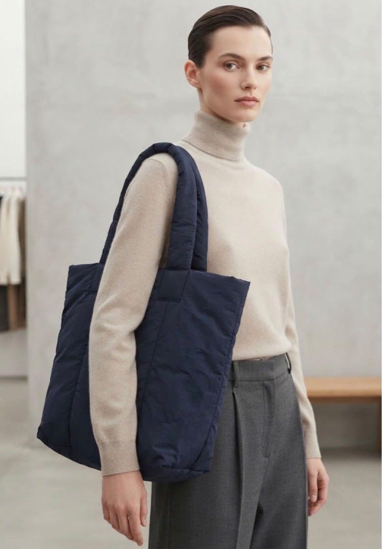 COS Padded Tote Bag Navy Blue (Category: Tote Bags) located in Donsol. Submitted by saksthriftavenuebyluckymaria8 (Listing ID 1463341274, Image 1). Description: - Navy blue padded tote bag from COS - Lightweight and spacious design - Ideal for everyday use or travel - button closure COS Padded Nylon Tote Bag large 14in x 8in base , 17in length, handle drop 11in width 18.5in Almost new.