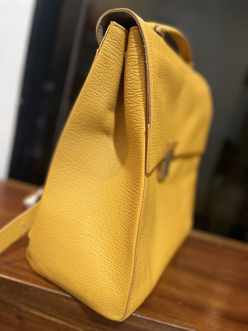 Couronne Yellow Leather Backpack (Category: Backpacks) located in Bacolod City. Submitted by vintage_vogue6100 (Listing ID 1463372944, Image 3). Description: - Brand: Couronne - Color: Yellow - Material: Leather - Features: Top handle, adjustable backpack straps, gold buckle front closure - Interior: Multiple pockets for organization - Ideal for: Everyday use, travel.
