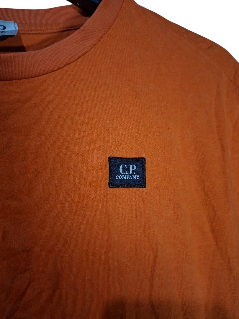 C.P. Company Orange T-Shirt with Logo Patch (Category: Tshirts & Polo Shirts ) located in Leyte. Submitted by jpsrvd19 (Listing ID 1463462902, Image 2). Description: - C.P. Company T-shirt - Features the iconic C.P. Company logo patch on the chest - Made from comfortable, breathable cotton - Ideal for casual everyday wear - Authenticity details available on the care label.