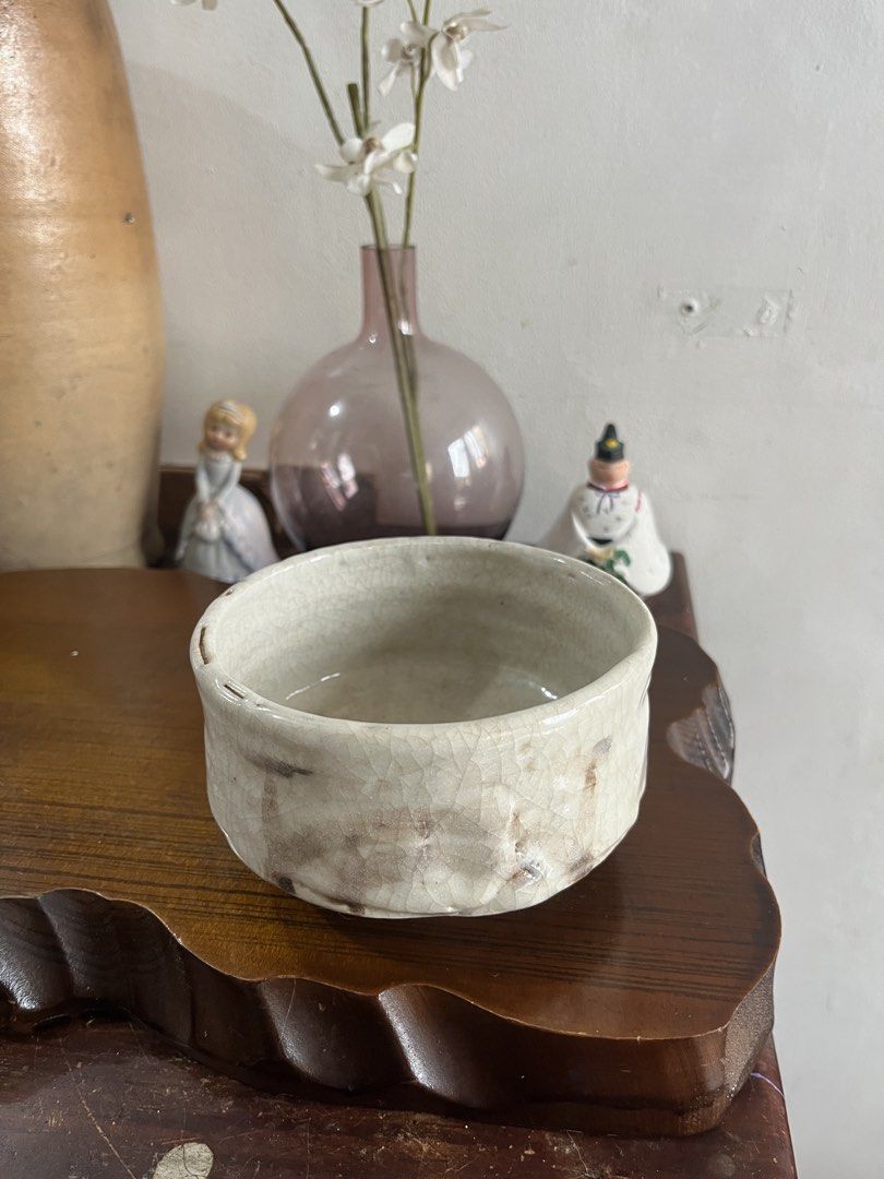 Crackle Glaze Ceramic Bowl (Category: Other Kitchenware & Tableware) located in Taguig. Submitted by minmin_parker (Listing ID 1463391849, Image 1). Description: - Vintage-style ceramic bowl - Unique crackle glaze finish - Rough and rustic texture - Light, off-white color with darker exterior marks - Approximately 5 inches in diameter - Ideal for display or as a small catch-all dish.