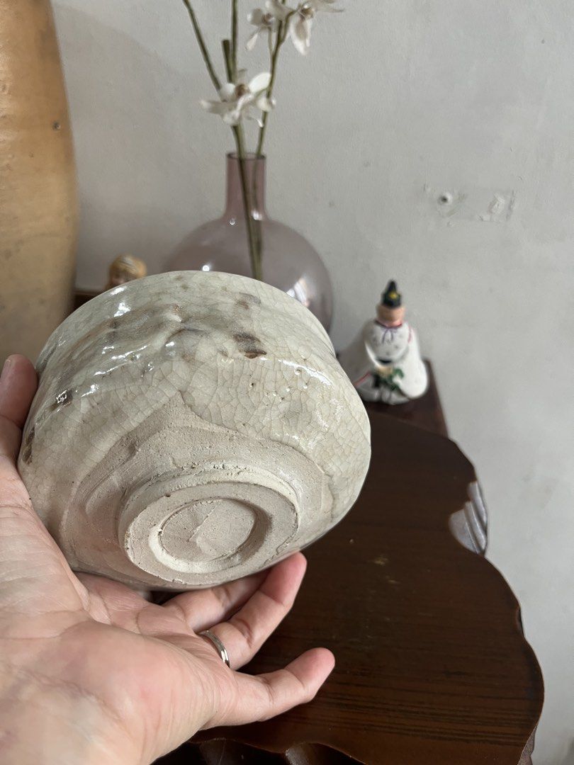 Crackle Glaze Ceramic Bowl (Category: Other Kitchenware & Tableware) located in Taguig. Submitted by minmin_parker (Listing ID 1463391849, Image 3). Description: - Vintage-style ceramic bowl - Unique crackle glaze finish - Rough and rustic texture - Light, off-white color with darker exterior marks - Approximately 5 inches in diameter - Ideal for display or as a small catch-all dish.