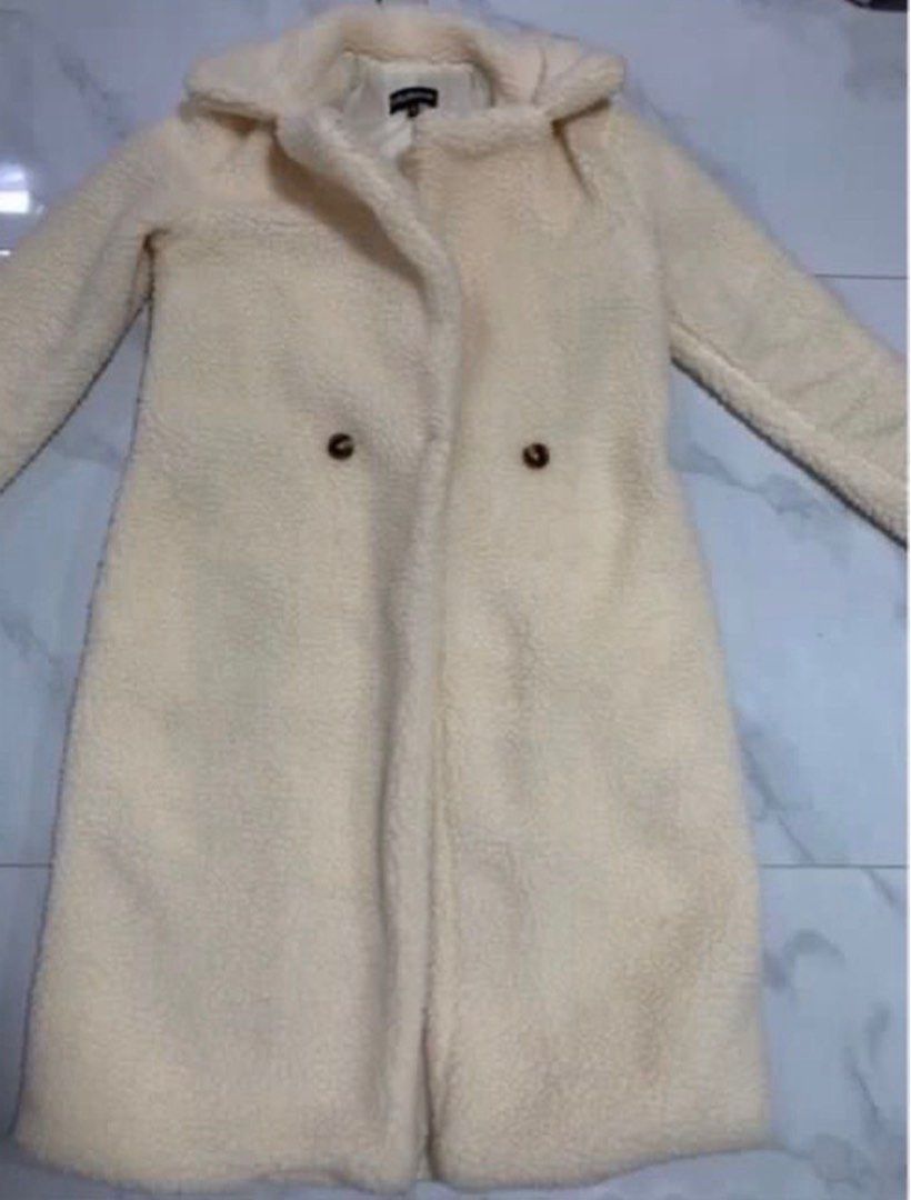 Cream Teddy Coat with Double Breasted Buttons (Category: Coats, Jackets and Outerwear) located in Manila. Submitted by decluterthings888 (Listing ID 1463548005, Image 1). Description: - Super cozy cream teddy coat - Long length, ideal for colder days - Classic collar - Double-breasted button closure - Looks incredibly soft and warm - Great for layering over any outfit.