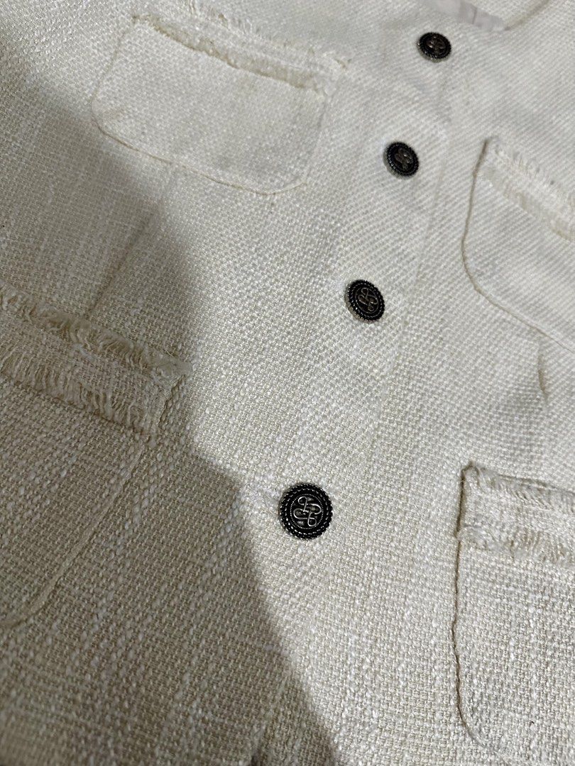 Cream Tweed Cropped Top with Buttons (Category: Coats, Jackets and Outerwear) located in Manila. Submitted by everythingsale101 (Listing ID 1463437570, Image 2). Description: - Cream cropped jacket from MVP - Textured tweed fabric with frayed edges - Four front pockets - Four dark buttons down the front - Short sleeves - Round neckline - Versatile for layering over tops or dresses - Creates a chic, put-together look Fits M-L (up to 38 bust) —Prem