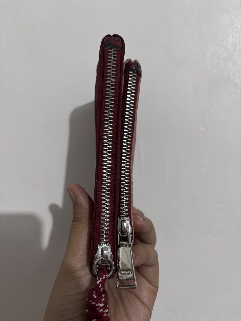 Cute Lips Pouch with Double Zippers (Category: Purses & Pouches) located in Manila. Submitted by fashionfinds21 (Listing ID 1463353032, Image 3). Description: - Small pouch with a fun lip print on one side. - Plain maroon on the other side. - Features two zippers for easy access. - Includes a cute rope pull on one zipper. - Perfect for organizing small essentials. - Shows some signs of wear on the edges of the zippers. .