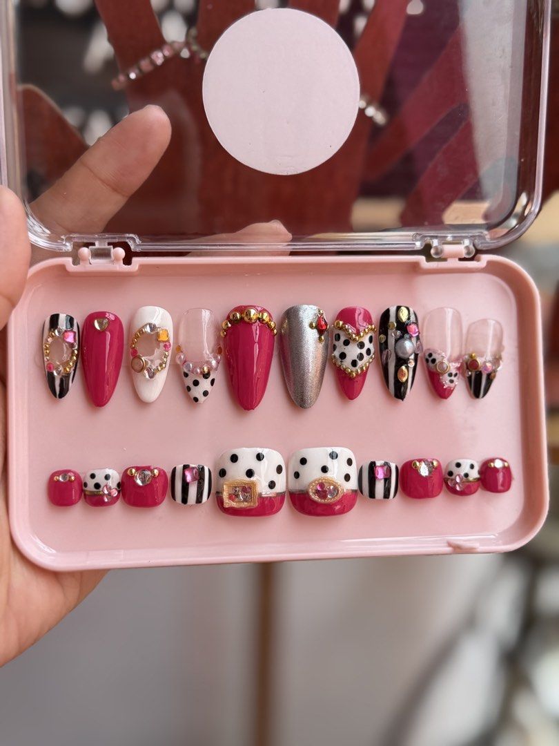 Cute Pink & Black Press-On Nails Set with Gems (Category: Hands & Nails) located in Antipolo. Submitted by jincute23 (Listing ID 1463330453, Image 1). Description: -HANDMADE PRESS-on nails -medium size -with free glue kit - Complete set of press-on nails for both fingers and toes. - Adorable designs: pink, white, and black stripes, polka dots. - Embellished with sparkling gems for extra flair. - Perfect for a fun and decorative manicure/pedicure.