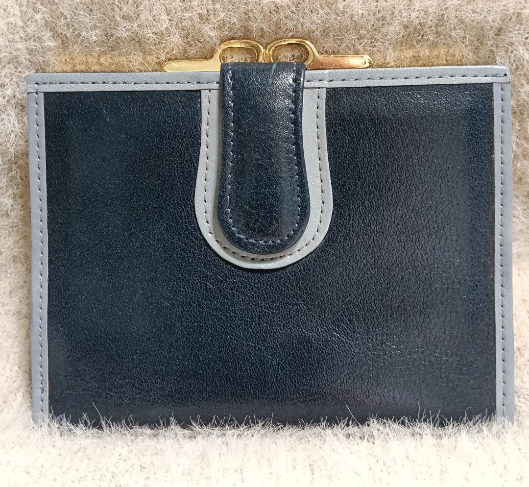 Dark Blue Leather Bi-fold Wallet with Gold Clasp (Category: Wallets & Card holders) located in Antipolo. Submitted by vastgem_4c8da8 (Listing ID 1463378864, Image 1). Description: - Dark blue genuine leather bi-fold wallet - Contrasting light grey trim - Secure gold clasp closure - Interior card slots - Bill compartment - Compact and practical for everyday use - Keeps essentials organized.