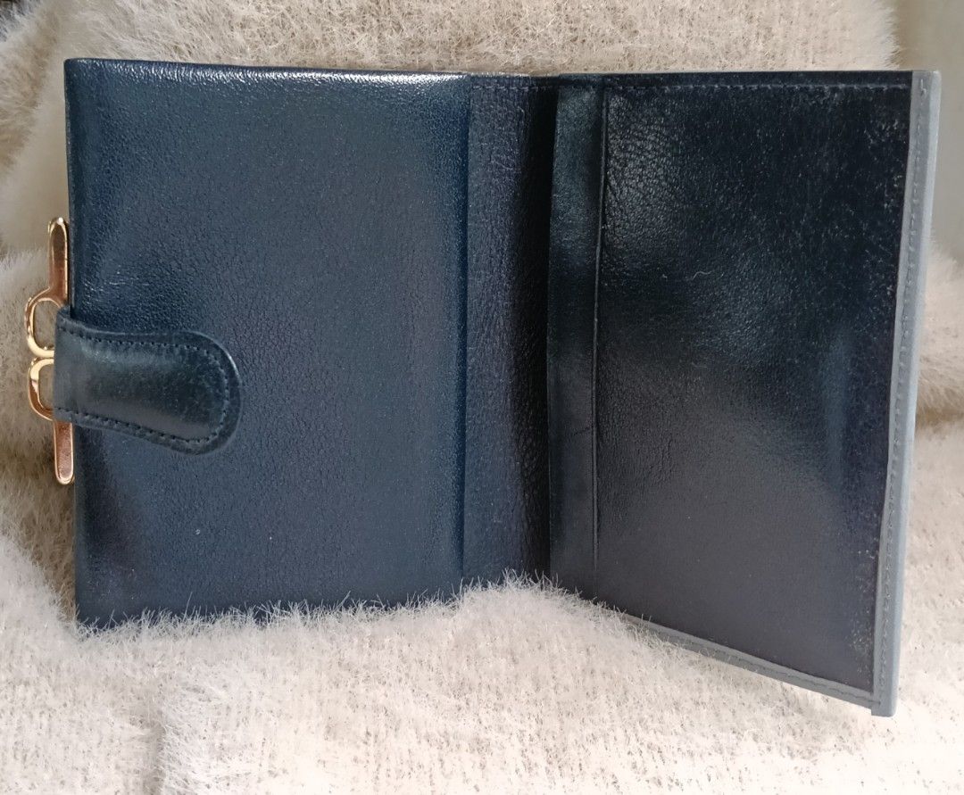 Dark Blue Leather Bi-fold Wallet with Gold Clasp (Category: Wallets & Card holders) located in Antipolo. Submitted by vastgem_4c8da8 (Listing ID 1463378864, Image 2). Description: - Dark blue genuine leather bi-fold wallet - Contrasting light grey trim - Secure gold clasp closure - Interior card slots - Bill compartment - Compact and practical for everyday use - Keeps essentials organized.