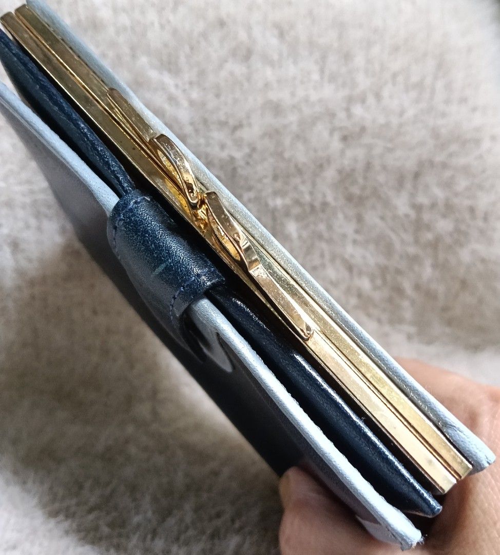 Dark Blue Leather Bi-fold Wallet with Gold Clasp (Category: Wallets & Card holders) located in Antipolo. Submitted by vastgem_4c8da8 (Listing ID 1463378864, Image 3). Description: - Dark blue genuine leather bi-fold wallet - Contrasting light grey trim - Secure gold clasp closure - Interior card slots - Bill compartment - Compact and practical for everyday use - Keeps essentials organized.
